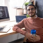 handsome-programmer-in-headphones-listening-to-mus-2023-11-27-04-56-48-utc