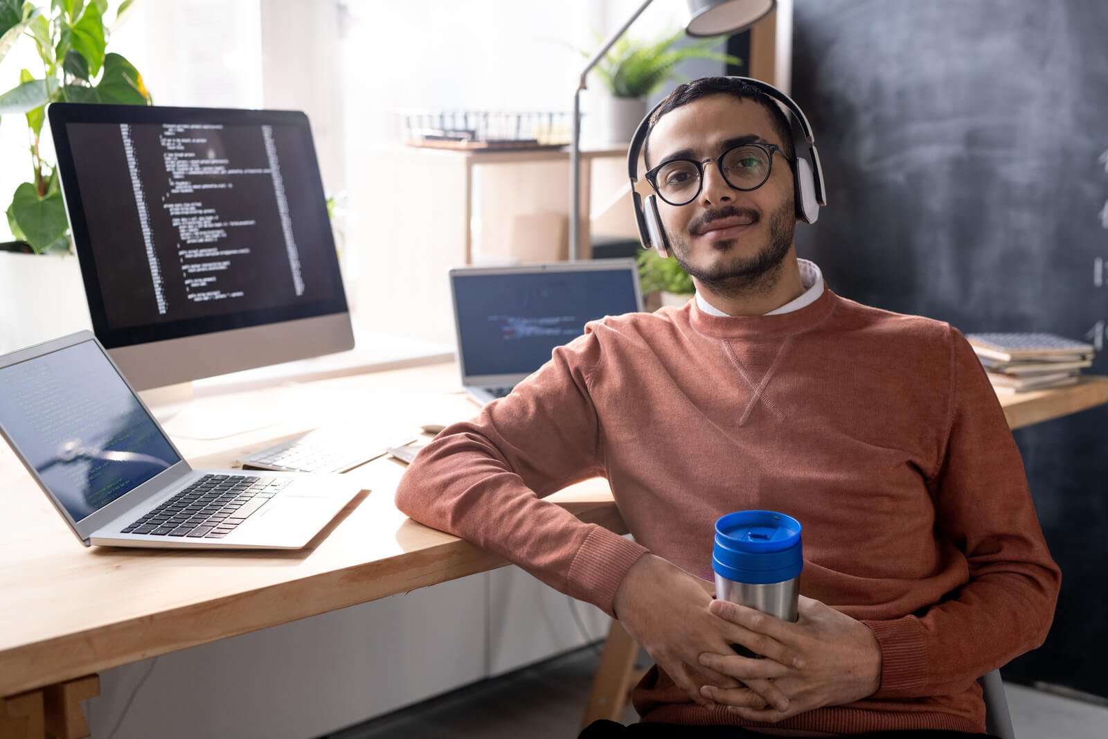 handsome-programmer-in-headphones-listening-to-mus-2023-11-27-04-56-48-utc.jpg